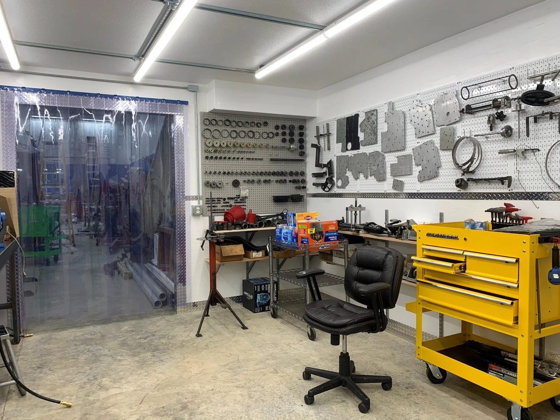 Transmission rebuild room with valve bodies and internal components on the wall