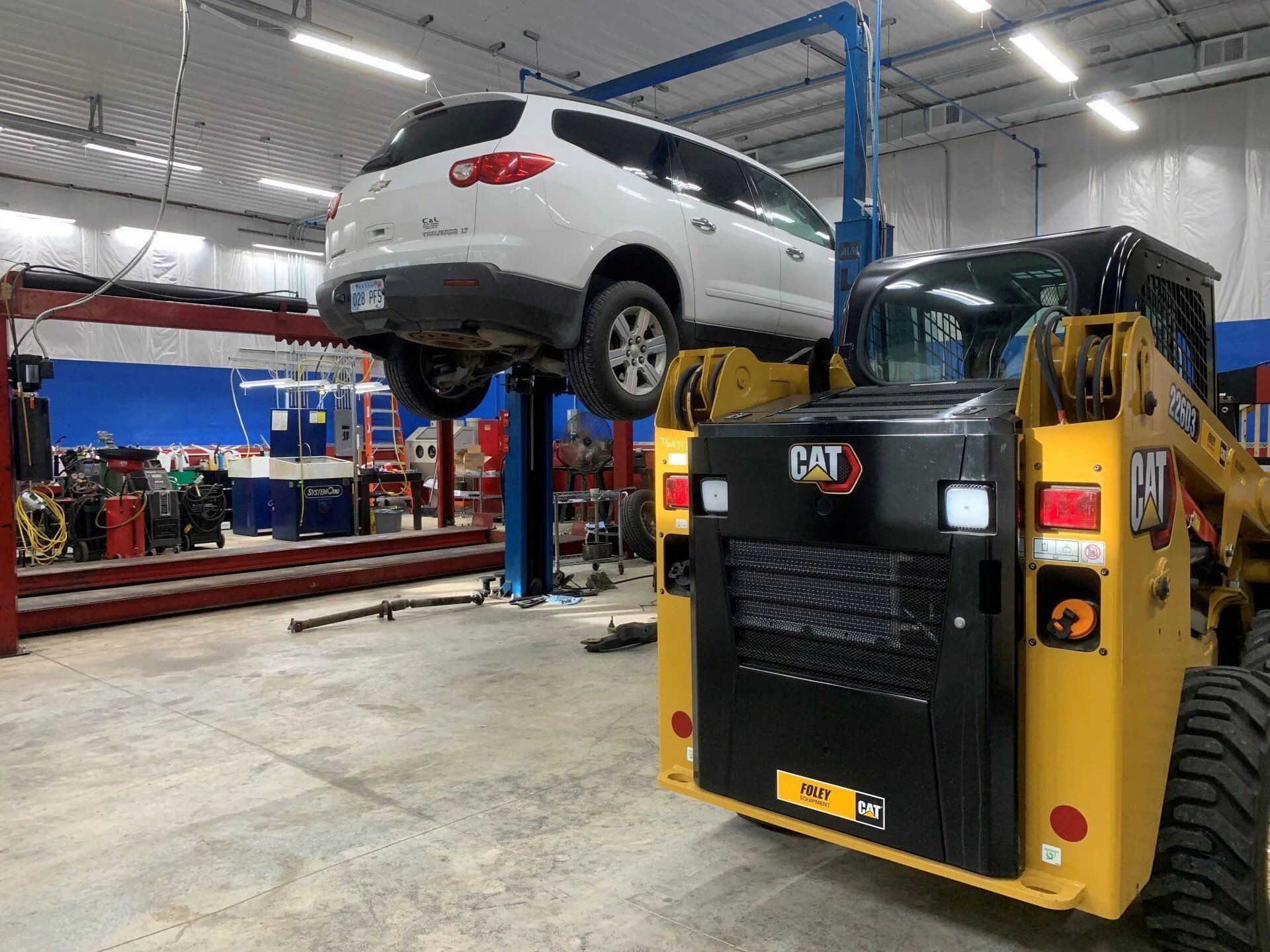 A vehicle on a lift in the Tim Worthy's Transmission service bay