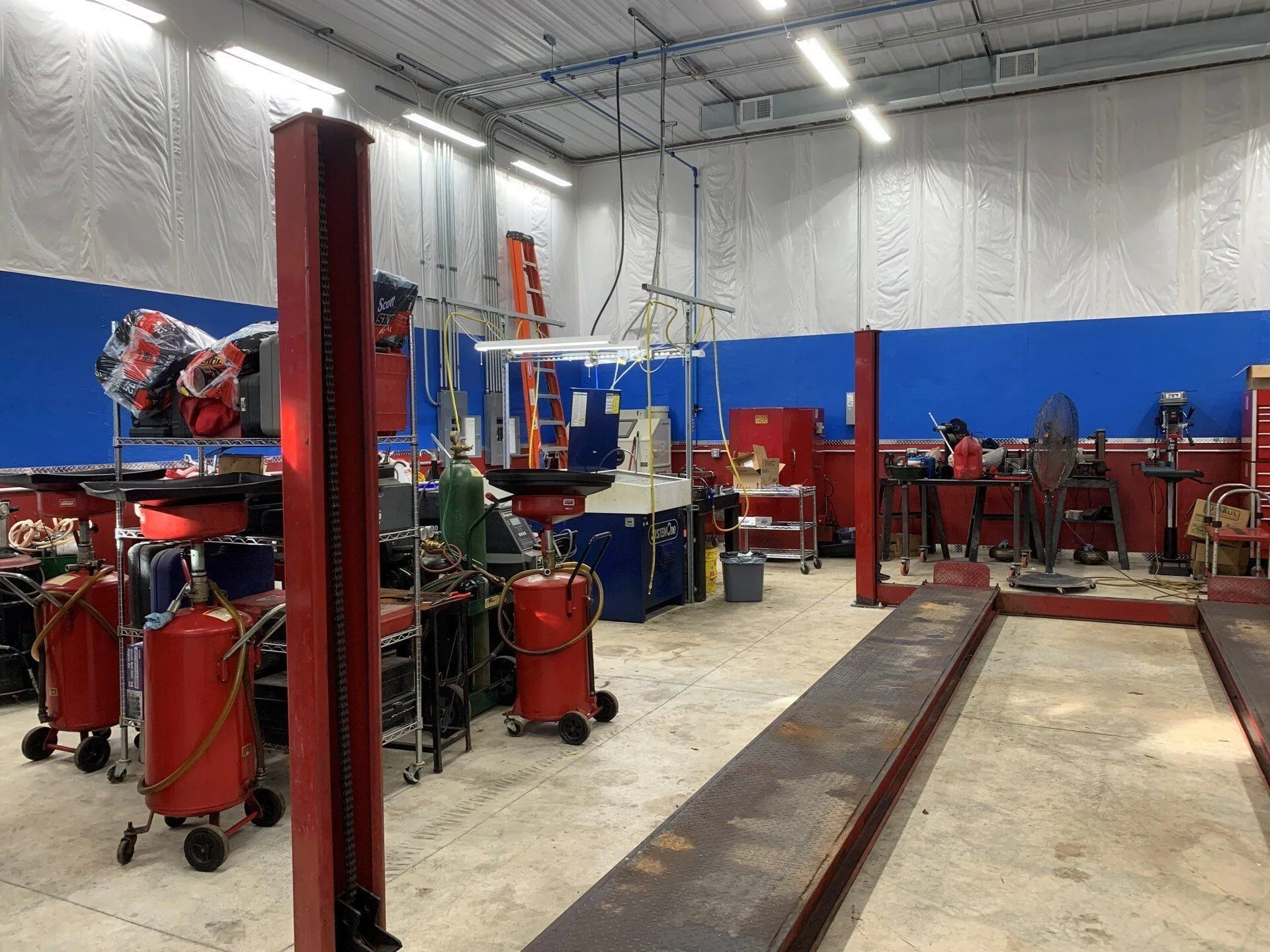 A mechanic's shop with a lot of tools and equipment.